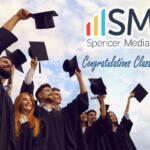 Group of graduates in caps and gowns cheering, with ISMG Spencer Media Group logo and 'Congratulations Class of 2026!' text in the sky.