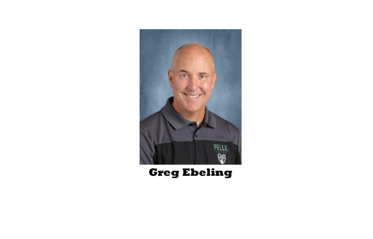 Portrait of Greg Ebeling, smiling, wearing a gray polo with a Pella logo against a blue background.