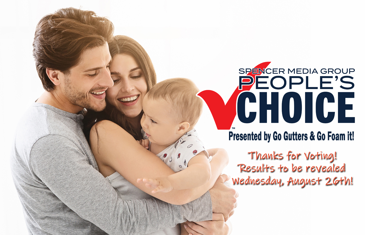 Smiling family of three embracing beside a 'People's Choice' voting promo by Spencer Media Group with 'Thanks for voting!' message and results date nearby.