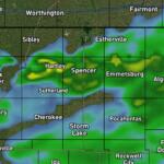 Weather radar showing light to moderate rain across northwest to north-central Iowa, with towns like Hartley, Spencer, Emmetsburg, Pocahontas, Cherokee, Sioux Center, and Sioux City.