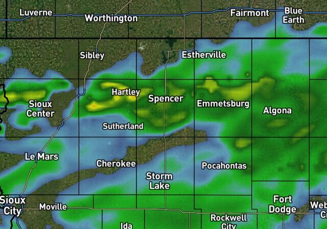 Weather radar showing light to moderate rain across northwest to north-central Iowa, with towns like Hartley, Spencer, Emmetsburg, Pocahontas, Cherokee, Sioux Center, and Sioux City.