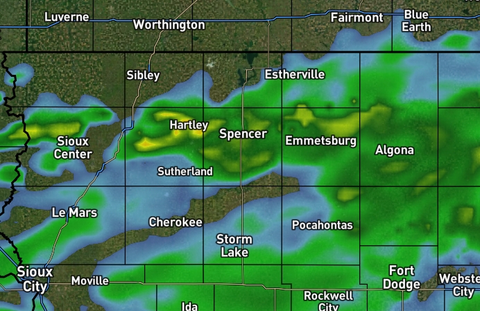 Weather radar showing light to moderate rain across northwest to north-central Iowa, with towns like Hartley, Spencer, Emmetsburg, Pocahontas, Cherokee, Sioux Center, and Sioux City.