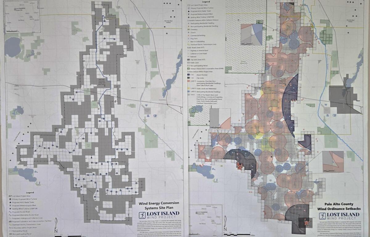 Large printed map showing wind energy site plan with dense zoning/legend details, laid out on a wall.
