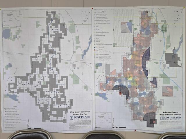 Large printed map showing wind energy site plan with dense zoning/legend details, laid out on a wall.