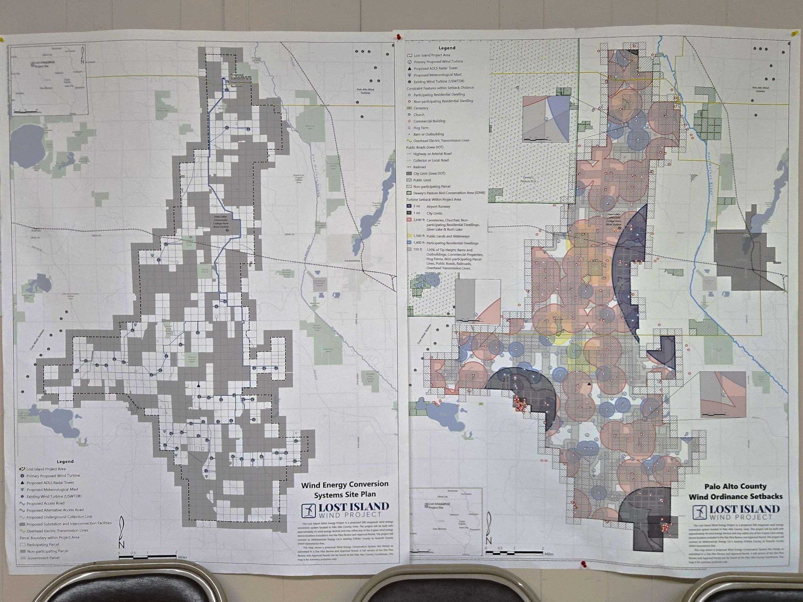 Large printed map showing wind energy site plan with dense zoning/legend details, laid out on a wall.