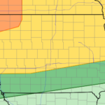Regional map with diagonally oriented colored bands (orange to green) indicating varying risk/coverage; state boundaries faintly visible.